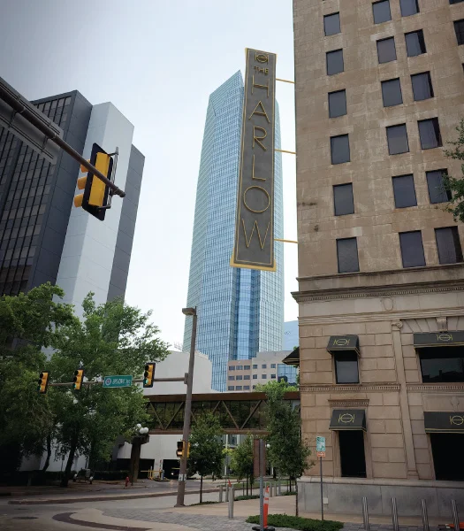 the harlow signage outside in daytime with Devon tower visible behind in skyline