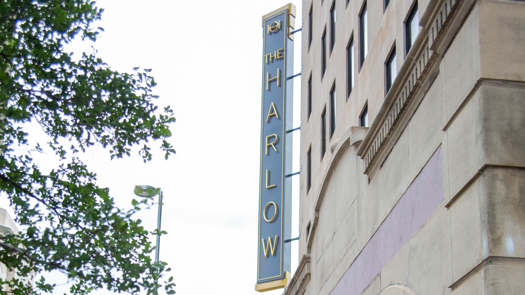 Exterior building sign for The Harlow.